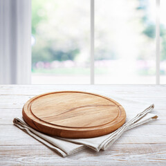 Napkin and board for pizza on wooden desk. Kitchen background.