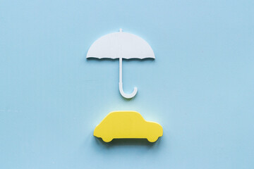Buy car insurance concept. Car shape under umbrella