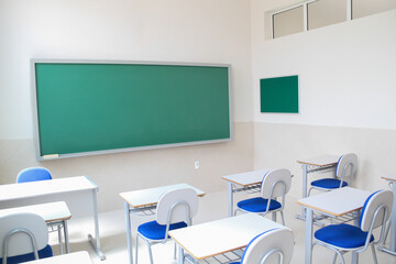 New empty, lit classroom ready to start school, closed because of the coronavirus pandemic.