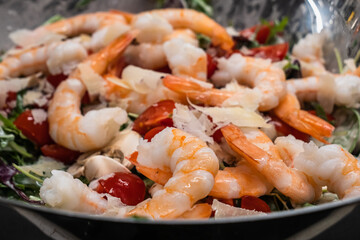Arugula or Rocket Salad with Prawns or Shrimps, Tomato, Parmesan Cheese and Button Mushrooms, Served in a Silver Bowl