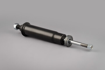 Trucks Cabin Shock Absorber, New auto parts, spare parts Cabinedemper. Shock absorber on a gray background.
