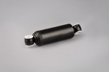 Truck seat shock absorber on gray background. Trucks Cabin Shock Absorber, New auto parts, spare parts Cabinedemper. Shock absorber on a gray background.