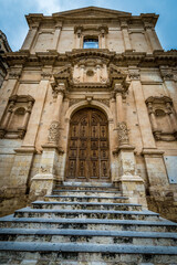 Fototapeta na wymiar Portal of St Francis of Assisi church in historic part of Noto city, Sicily in Italy