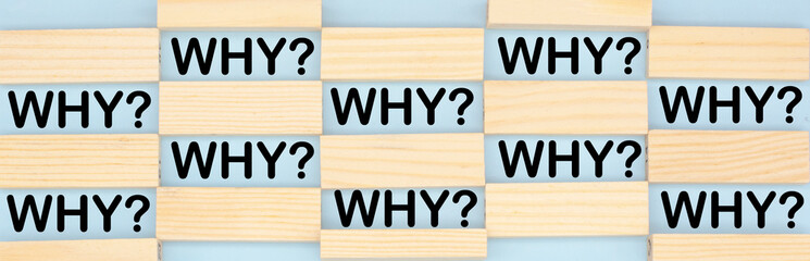 the word why among the wooden blocks. Concept of questions