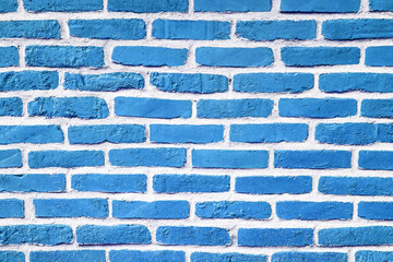 Blue paint brick wall. Abstract color home facade background. Decorative artistic urban...