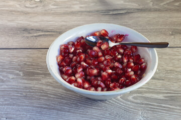 Juicy ripe pomegranate grains. Concept of vegan dessert.
