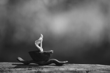 A toy little sailboat on a dark background.