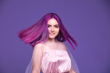 Model girl young beautiful stylish with hair dyed purple on violet background