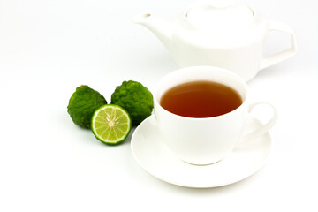 Bergamot tea in white ceramic cup and fresh bergamot fruit and sliced isolated on white background.