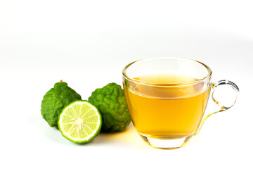 Bergamot tea in transparent cup and fresh bergamot fruit and sliced isolated on white background.
