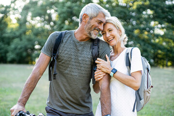 Smiling mature couple standing in forest