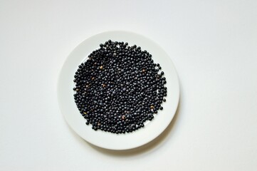 schwarze Linsen auf einem Teller