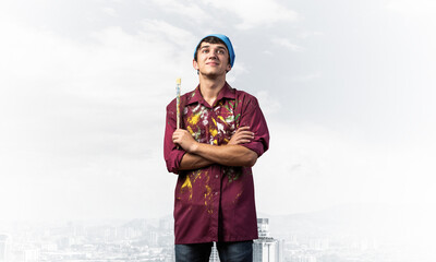 Young painter artist standing with folded arms