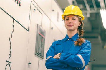 Portrait of young female electrical engineer in electrical control room