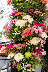 Fototapeta na wymiar Colorful different types of flowers are collected in huge bouquets. roses gerberas chrysanthemums in flower solution. combination of different types of flower plants in the florist's solution