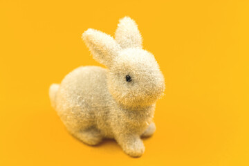 Cute Easter bunny decoration close-up photo on a yellow background