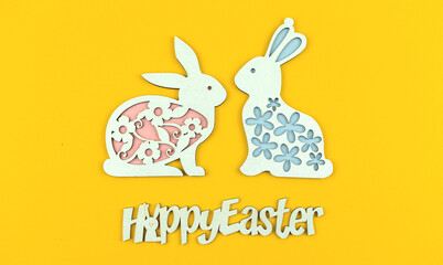 Fototapeta premium Easter bunny decoration on a yellow background, cute greeting card with text