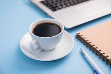 Office desk table with laptop computer, coffee cup