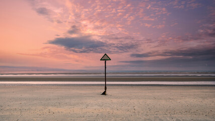 Beautiful beach coastal low tide landscape image at sunrise with colorful vibrant sky