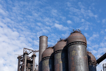 View up at Carrie Blast Furnaces of Homestead Steel Works against a brilliant blue sky, national historic landmark, horizontal aspect