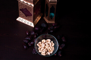 Arabic lantern with dates and cashews. Ramadan 2021 concept.