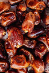 Dried dates, food background. Close-up of dates on a vertical background