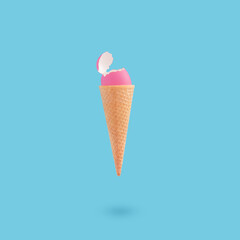Creative Easter concept with pink color eggshell in ice cream cone on blue background