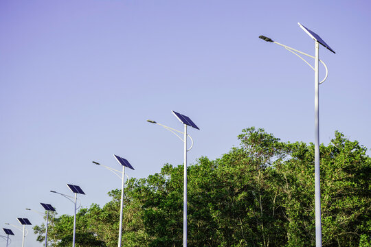 Solar cell lamp electricity system for alternative power energy on street with green tree nature, Future renewable supply source