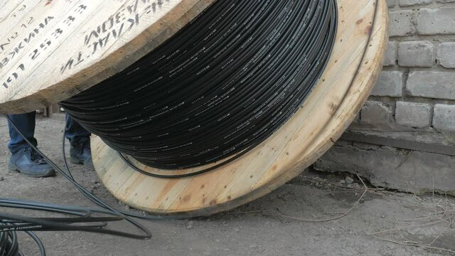 Close-up. fiber optic cable on a large wooden spool.