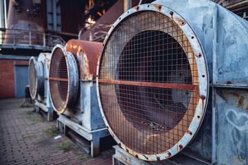 Fototapeta na wymiar rusty old turbines of a ventilation system in Landschaftspark Duisburg