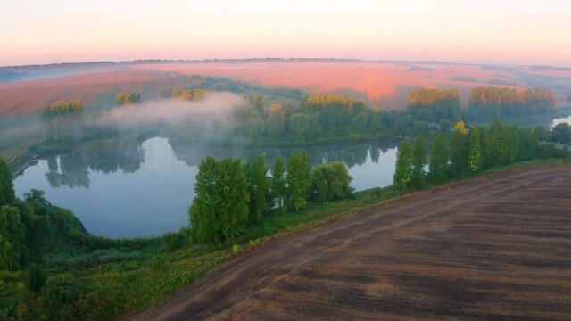 4K aerial - a bird's eye view&nbsp;video (Ultra High Definition). Summer sunrise on Ternopil outskirts with two lakes and asphalt road on the midle. Spectacular morning view of hte Ukrainian countryside..