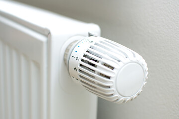 Thermostatic head and radiator valve. Close-up view. Energy saving and save money concept with copy space. Reduce consumption of gas or electricity.