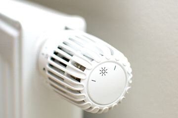 Thermostatic head and radiator valve. Close-up view. Energy saving and save money concept with copy space. Reduce consumption of gas or electricity.