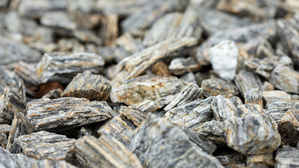 Crushed stone gray, light gray filling background close up
