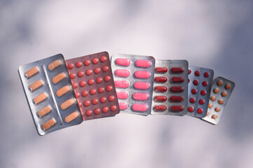 Red & Orange Color Capsule / Pills - Medicine on white background in natural light. Health themes.

