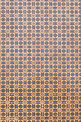historical azulejos tiles, facade decoration portugal. beautiful geometric pattern in orange white and blue colors. architectural background