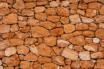texture of a old red stone wall mediterrranean spain architecture, wall background