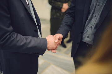 men in suits shaking hands