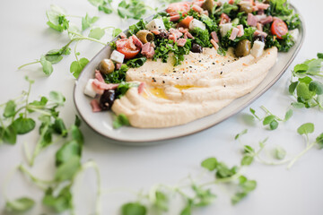 Healthy Hummus Salad with Fresh Tomatoes, Greens, and Spices