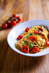 Fresh pasta with garlic Cherry Tomatoes and basil. Deliciosu  Pasta Plate. Raw vegan pasta. Spaghetti. Italian food. Italy. Roma. Fine dining. Healthy food. Fresca Pasta. Vegetarian