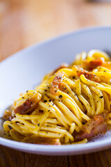 Spaghetti carbonara with egg  parmesan cheese and guanciale meat. Ingredients for fresh carbonara pasta. Spaghetti carbonara. Italian recipe. Fresh food. Macro Food Photography. Close Up