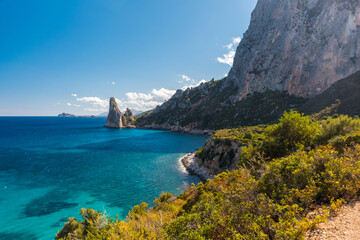 Naklejka premium Coastline near Santa Maria Navarrese with rock pinnacle called Pedra Longa in the background (Sardinia, Italy)