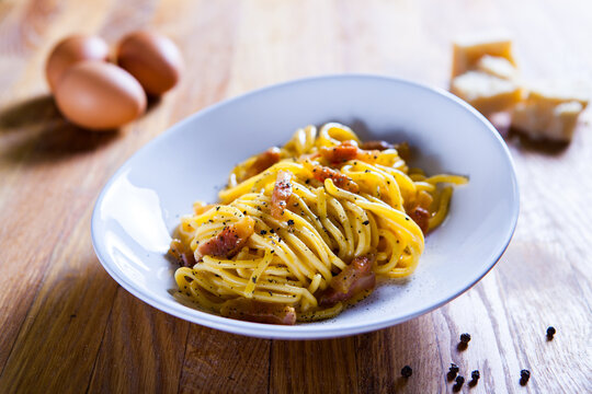 Spaghetti carbonara with egg  parmesan cheese and guanciale meat. Ingredients for fresh carbonara pasta. Spaghetti carbonara. Italian recipe. Fresh food. Macro Food Photography. Close Up
