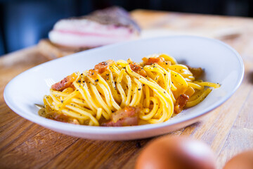 Spaghetti carbonara with egg  parmesan cheese and guanciale meat. Ingredients for fresh carbonara pasta. Spaghetti carbonara. Italian recipe. Fresh food. Macro Food Photography. Close Up