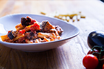 Pasta in red tomato sauce with onion and guanciale meat. Fresh pasta recipe

