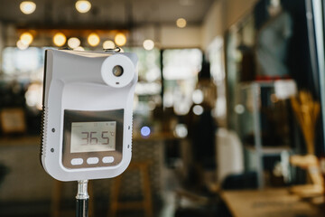 Infrared Thermometer or Handheld Digital Thermometer stand in front of coffee shop