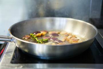 Fresh onion and guanciale  pork jow bacon fried in oil in the pan. fried ingredients for fresh pasta. Italian food recipe