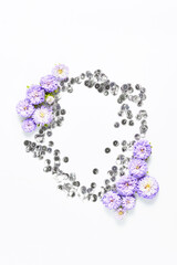 holiday layout. beautiful frame of silver shiny and fresh purple flowers on a white background. space for text