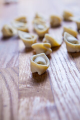 Fresh raw homemade tortellini or ravioli pasta. Arrangement of homemade italian Tortellini.  Freshly prepared homemade raw pasta recipe. Traditional Italian cuisine concept. Fresca Pasta in the pot