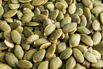 Roasted pumpkin seeds background, close up